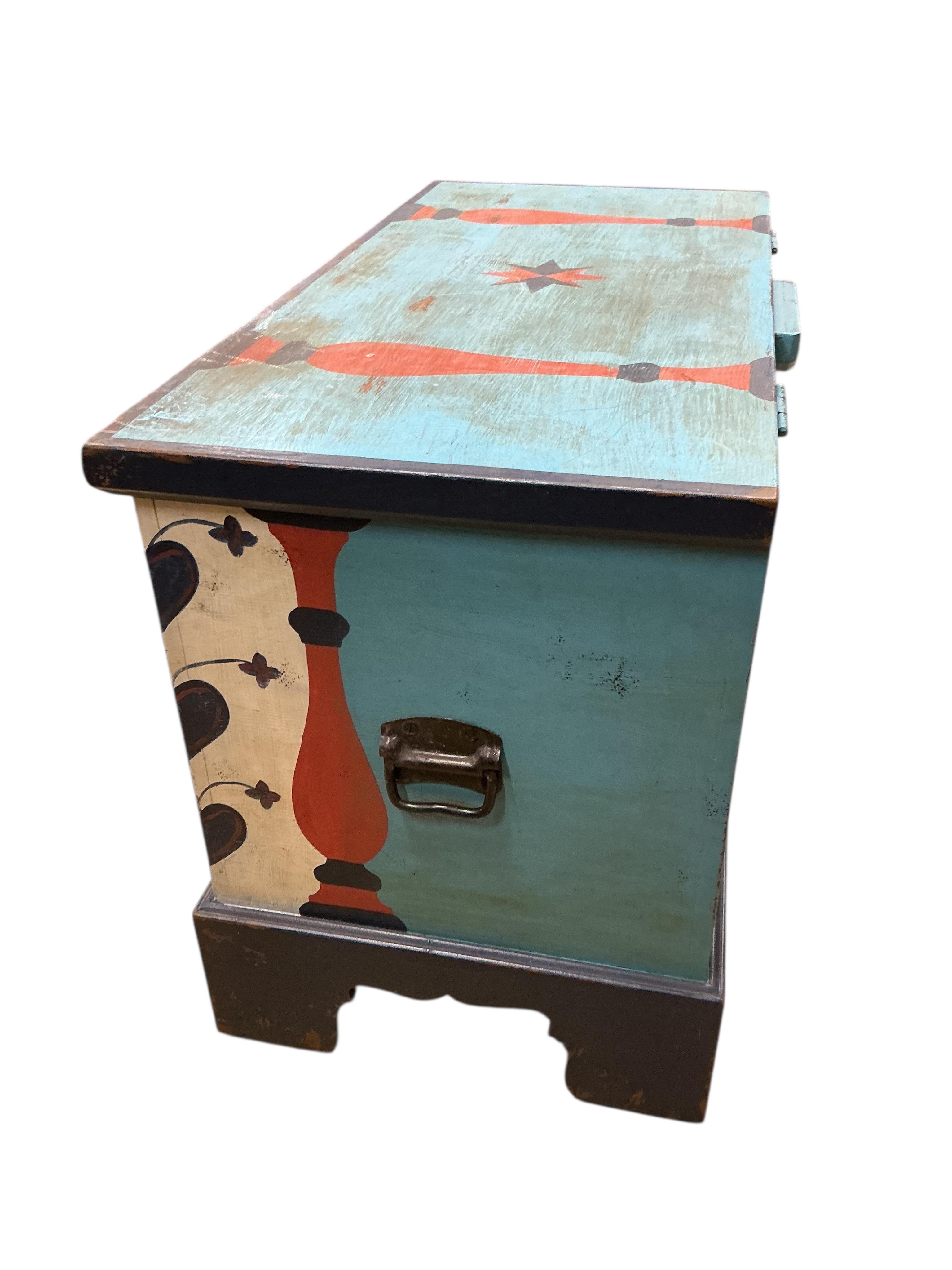 A painted chest, floral decorated and inscribed, width 102cm, depth 49cm, height 67cm